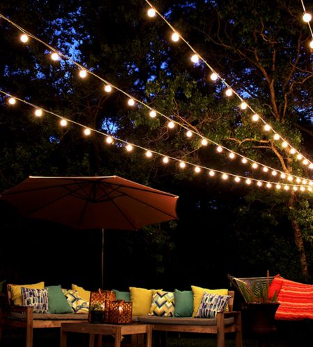 Warm-string-lights-on-a-pergola-a-cozy-outdoor-lighting-idea.jpg